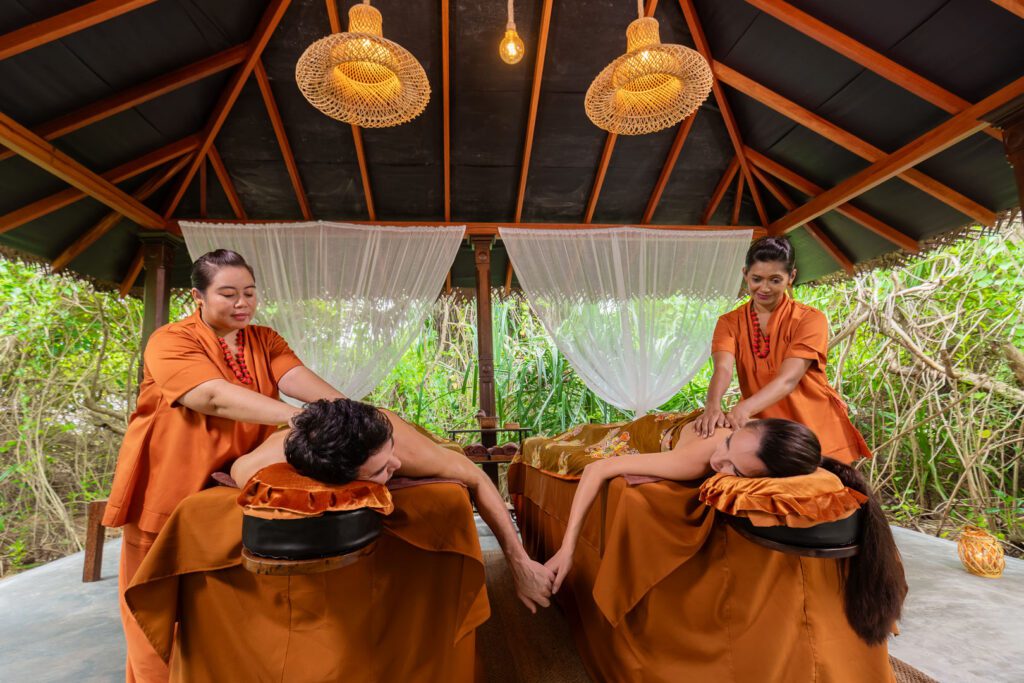 A couple receiving a herbal spa treatment