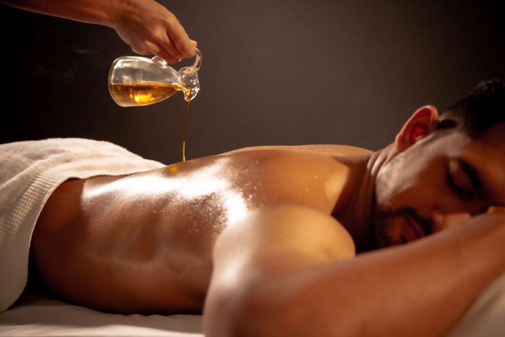 Man receiving a herbal oil treatment