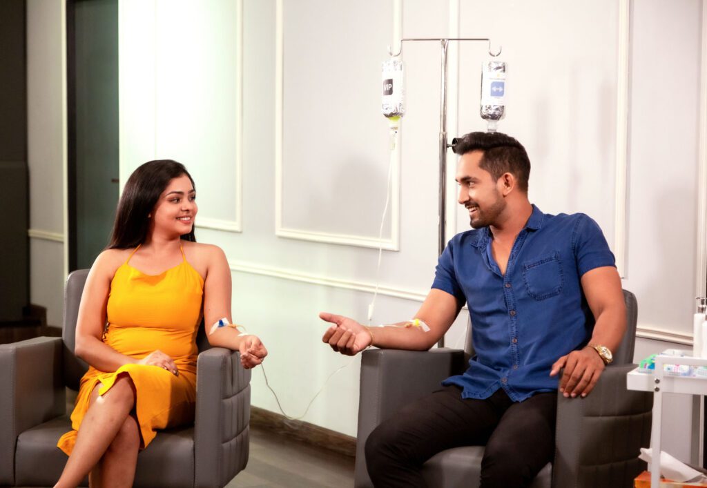 A couple receiving nutrition IV therapy
