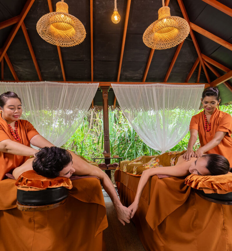 A couple receiving a herbal spa treatment