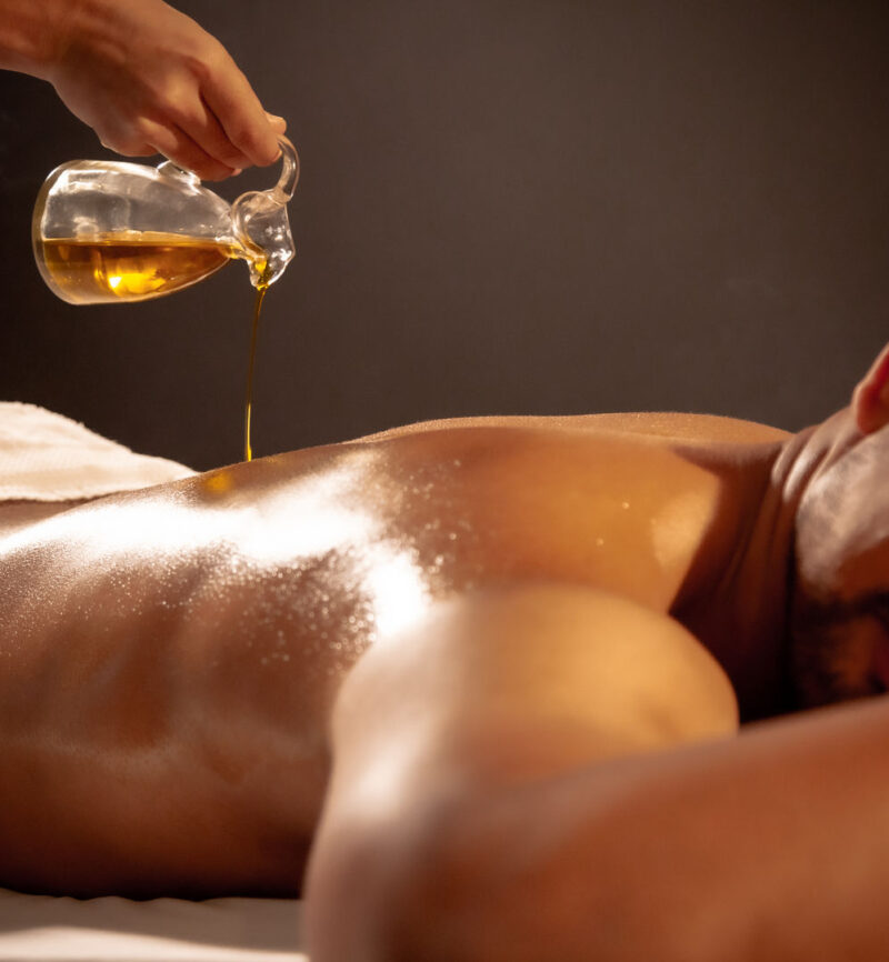 Man receiving a herbal oil treatment