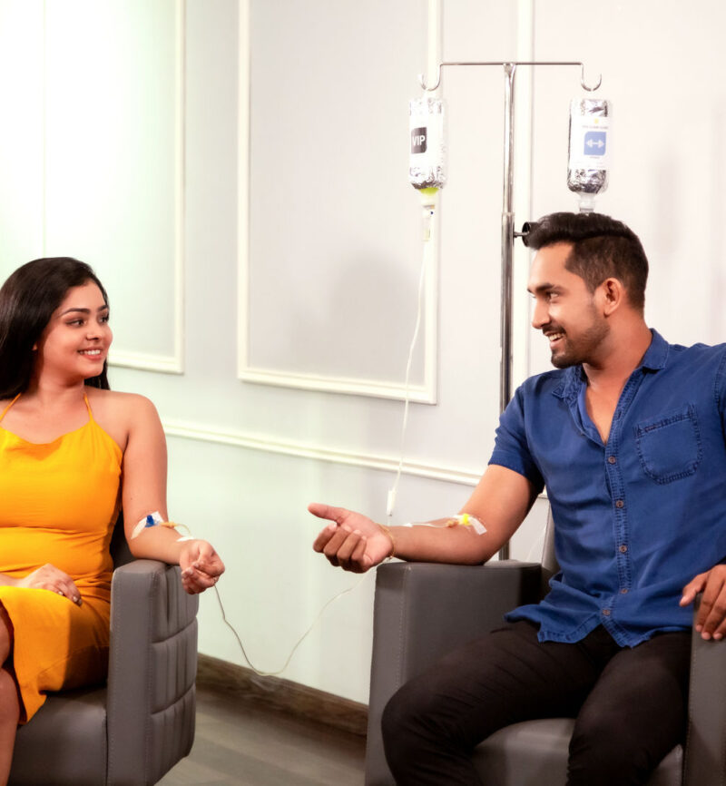 A couple receiving nutrition IV therapy